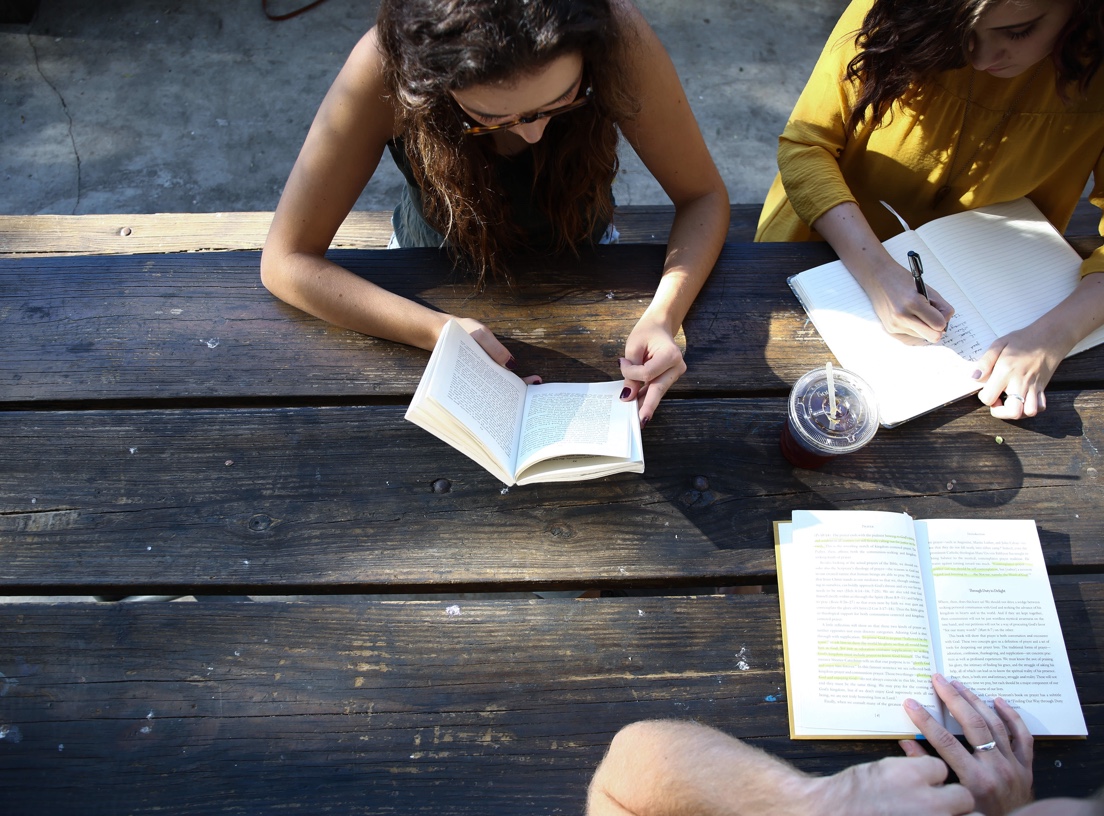 Students at a table reading books